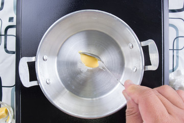Chef putting butter to the pan before cooking