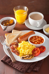 full english breakfast with scrambled eggs, bacon, sausage, bean