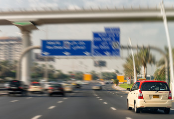 Fast moving Dubai taxi along city main road