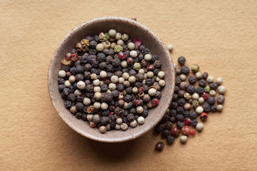 Mix of pepper in bowl on paper background
