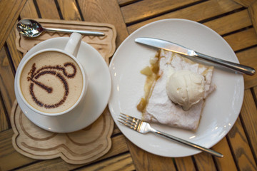 Cup of coffee and apple strudel with ice cream