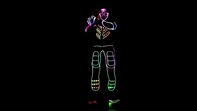 4 people dancing in costumes of LEDs 