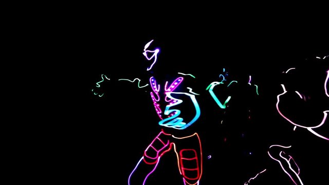 4 people dancing in costumes of LEDs 