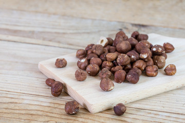 Bunch of hazelnuts on the rustic wooden boards table