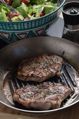 Steak cooking on grille pan. Fresh, delicious, spicy meat on a kitchen with copy space closeup
