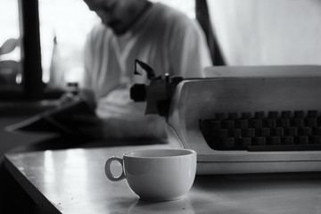 Novelist with Typewriter in Foreground