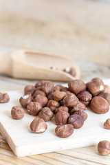Pile of raw hazelnuts on rustic wooden table