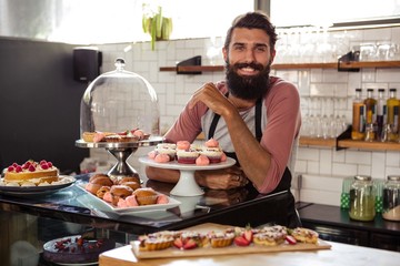 Fototapeta na wymiar Waiter posing with cakes