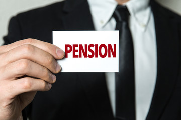 Business man holding a card with the text: Pension