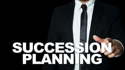 Business man pointing the text: Succession Planning