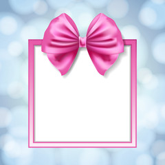 pink bow and square box frame on blurry light blue background