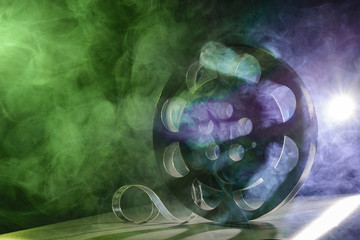 Metal reel of film is in the smoke