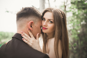 Fototapeta premium Kissing wedding couple in spring nature close-up portrait