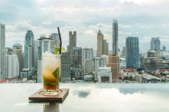 Mojito Cocktail On Table In Rooftop Bar With Bangkok City View