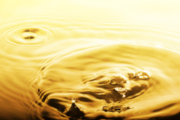 Liquid gold drop and ripple ,abstract background