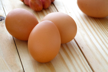 Eggs on wooden table with selective focus