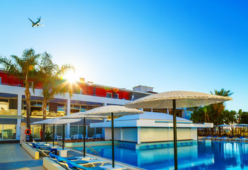 Fototapeta na wymiar modern European resort. sun. flying the aircraft. pool with bar