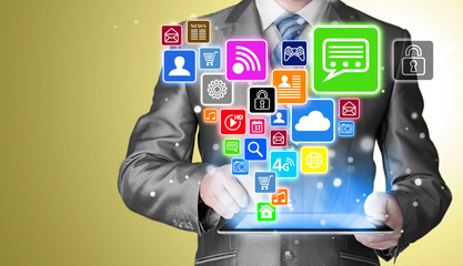 Business man using tablet PC with social media icon set