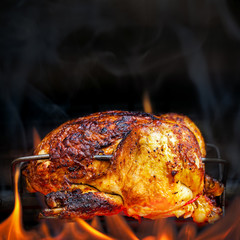 Rotisserie Chicken Cooking Over Open Flames © adogslifephoto