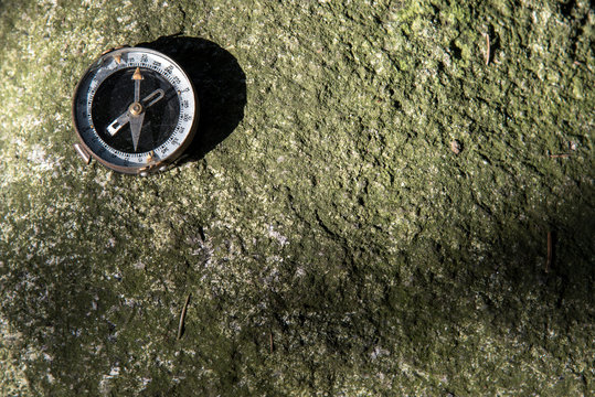 compass on a srone surface (background)