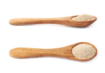 Wooden spoon filled with dry yeast