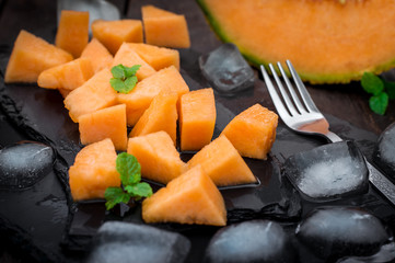 Pieces of Melon on a Granite Plate