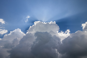 Blue sky with puffy white clouds in bright clear sunny day