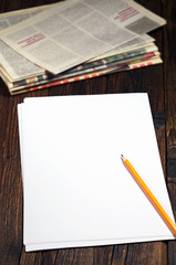 Blank sheet of paper and newspaper