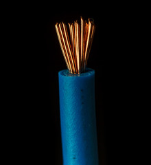 Stripped cords of wire power cord on black background