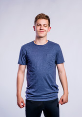 Boy in black sports trousers and t-shirt, studio shot