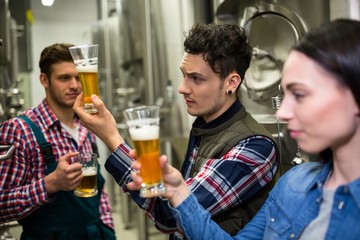 Brewers testing beer at brewery factory