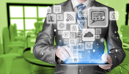 Business man using tablet PC with social media icon set
