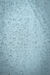 Rain water drop on light blue background