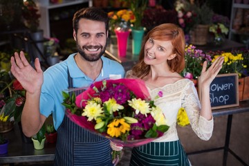 Portrait of couple holding flower bouquet