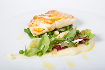 Fried white fish fillet with garnish