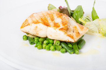 Fried white fish fillet with garnish