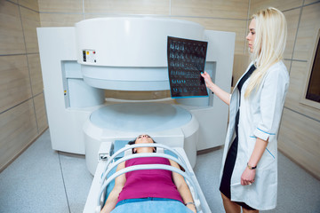 Medical equipment. Doctor and patient in MRI room at hospital.