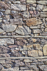 Stone wall background with wooden beams closeup