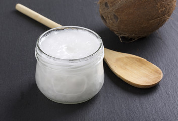 Coconut oil in a glass jar on a black