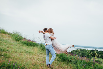 Fototapeta premium Happy Bride and groom walking on the green grass