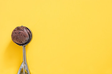 Chocolate ice cream on yellow background

