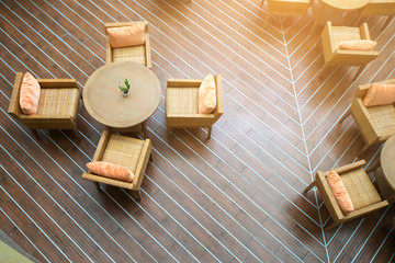 Table with four chairs in the sun on wooden floors