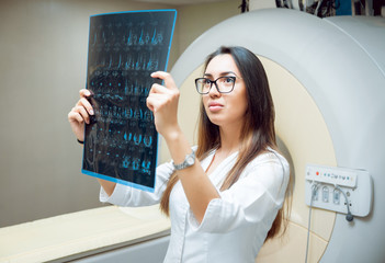 Medical equipment. Doctor looking MRI picture
