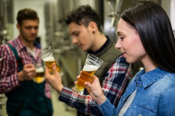 Brewers testing beer at brewery factory