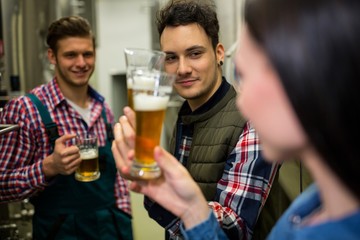 Brewers testing beer at brewery factory