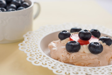 Anna Pavlova cake with strawberries, blueberries and cream cheese