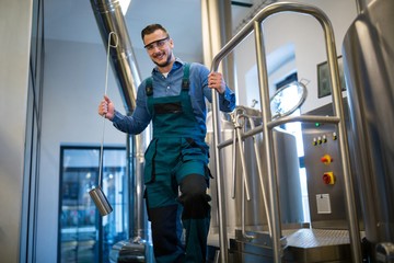 Brewer holding working equipment at brewery