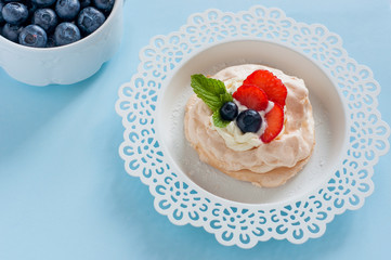 Anna Pavlova cake with strawberries, blueberries and cream cheese