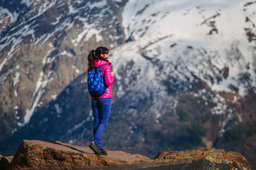 Naklejka premium Woman Traveler with Backpack hiking in Mountains with beautiful summer landscape on background mountaineering sport lifestyle concept