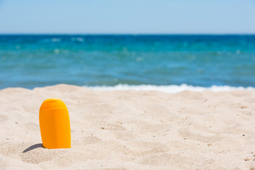 Sunscreen bottle on the beach